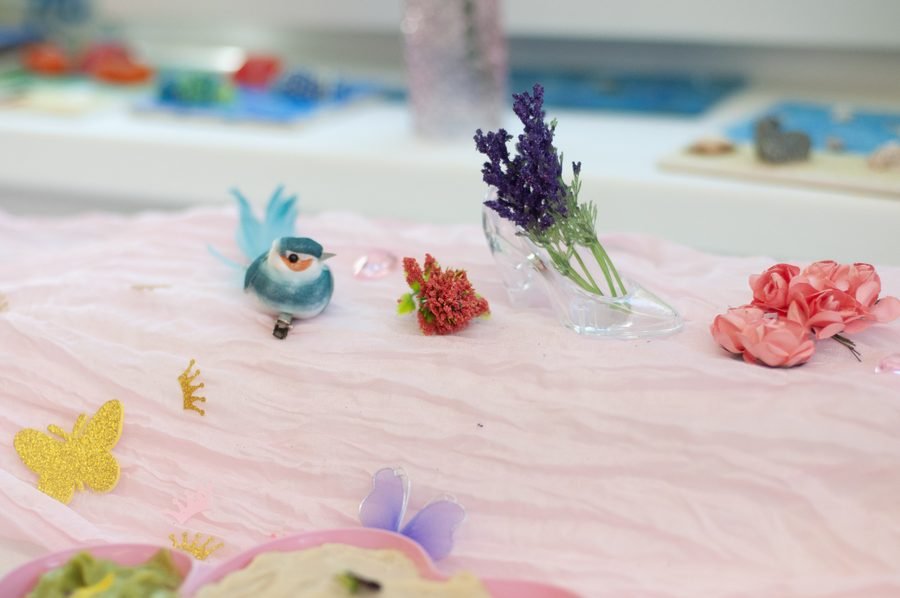 Princess party table styling details with glass slipper and flowers