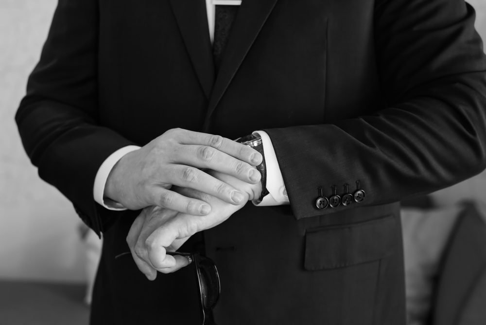 Groom checking his watch before the ceremony