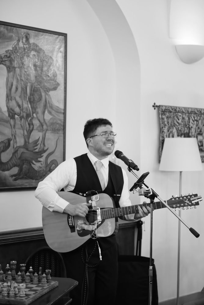 Live musician singing and playing guitar at the wedding reception